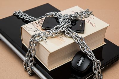 Share private info with bookkeeper Laptop and smartphone in chains for protection